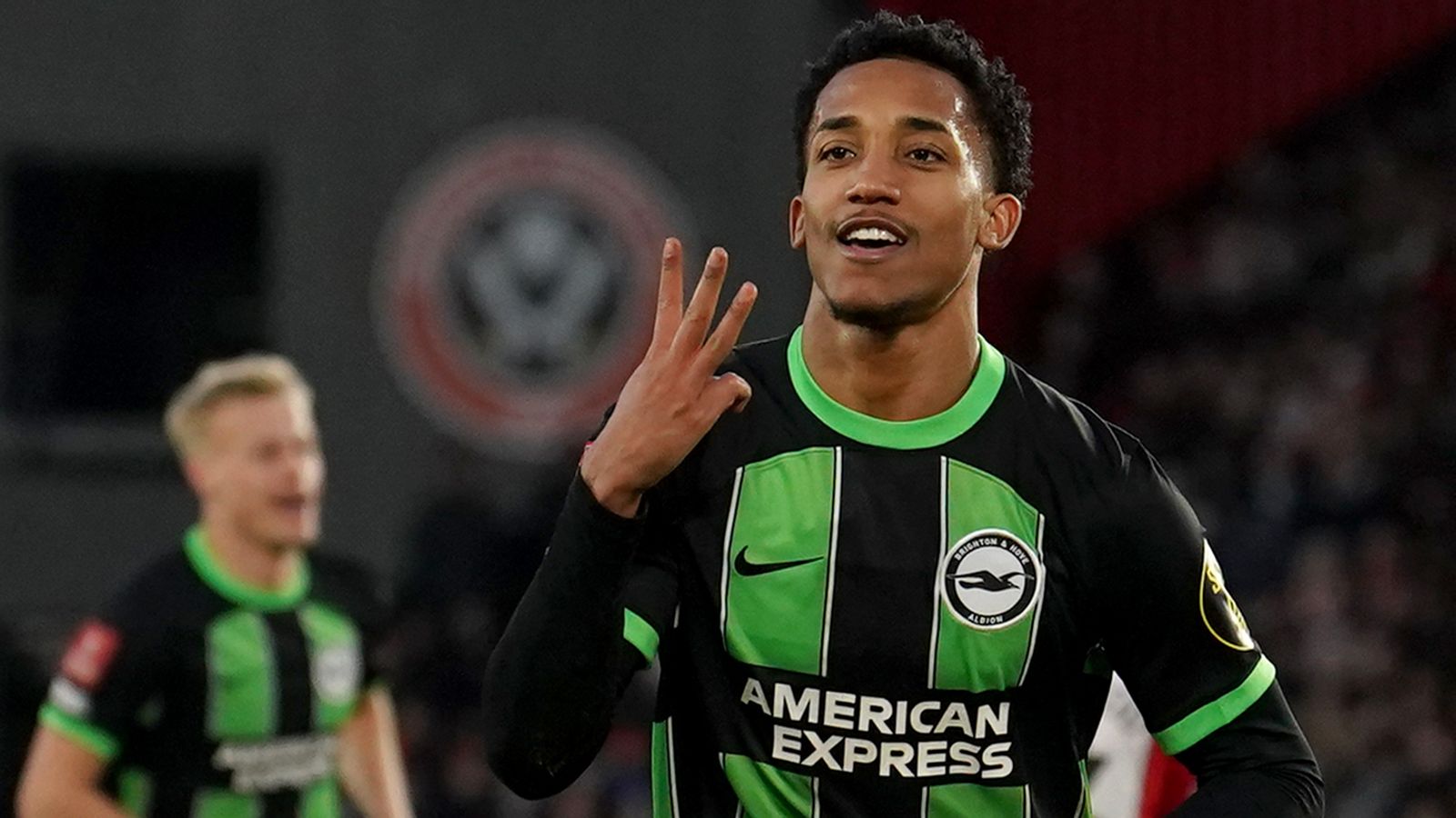 Joao Pedro holds up three fingers after completing his hat-trick